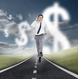 Businessman running on a road with dollars floating