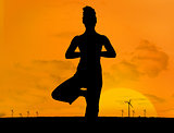 Silhouette of woman doing yoga outdoors