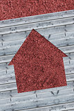 Cut wooden boards forming house with red texture
