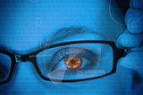Woman with orange eye wearing glasses