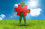 Green character holding a red jigsaw piece