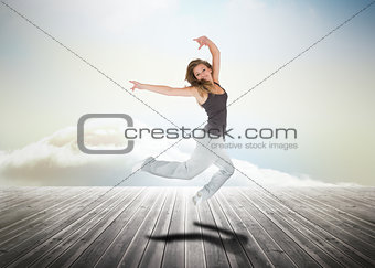 Woman jumping over wooden boards