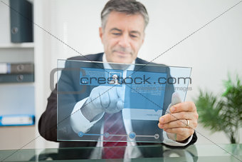 Businessman using futuristic touchscreen to view social media profile