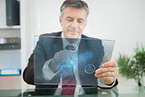 Businessman using futuristic touchscreen to view statistics