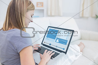 Woman sitting on couch and checking social media profile