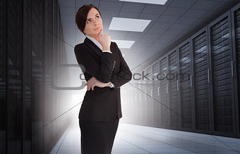 Businesswoman looking thoughtful in data center