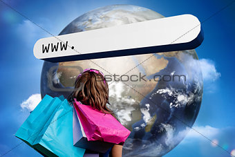 Girl with shopping bags looking at address bar with large earth
