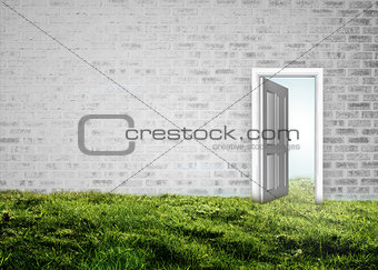 Doorway opening to blue sky in grey brick room