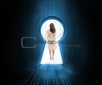 Businesswoman standing in keyhole doorway