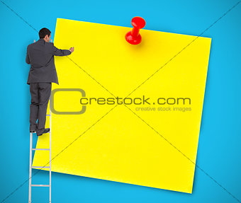 Businessman writing on a giant yellow post