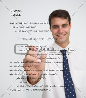 Smiling businessman writing in sql language