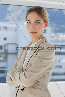 Businesswoman with arms crossed in her office