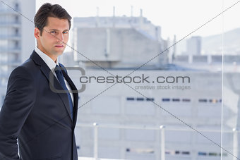 Handsome confident businessman standing