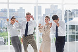 Group of business people raising arms as a success