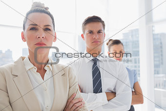 Serious attractive businesswoman standing with arms crossed
