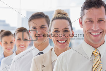 Smiling handsome businessman standing with his team