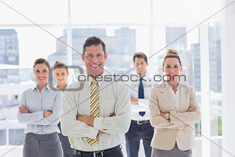 Smiling handsome businessman with his team