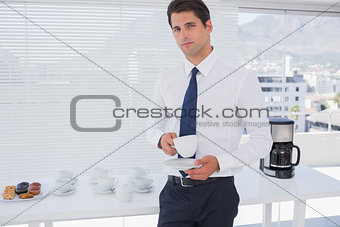Businessman having a coffee during the break
