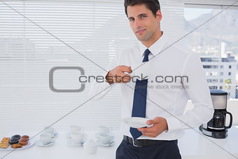 Smiling businessman having a coffee during the break