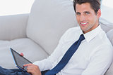 Smiling businessman using digital tablet