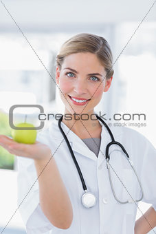 Woman doctor showing an apple