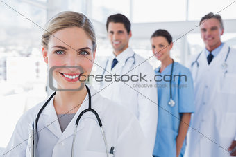 Woman doctor in front of her colleagues