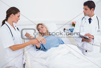 Doctor taking heartbeat of a patient