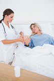 Hospitalized woman lying in sickbed