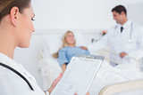 Doctor reading folder of a patient