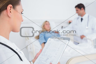 Doctor reading folder of a patient