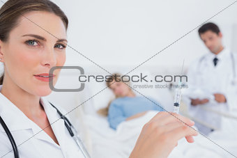 Serious doctor with a syringe