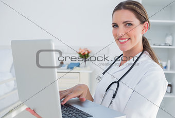 Woman doctor using laptop