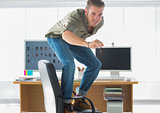 Smiling man surfing his office chair