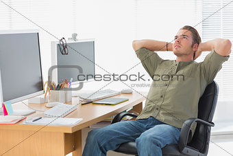 Handsome designer leaning back at his desk