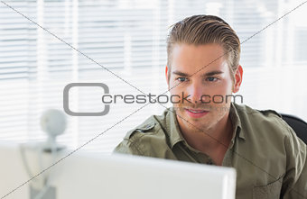 Creative business employee smiling during a videocall