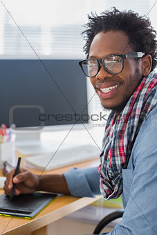 Cheerful graphic designer using a graphics tablet