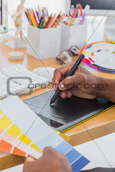 Interior designer with graphics tablet and colour chart