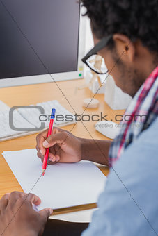 Creative business worker with reading glasses drawing something