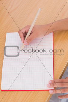 Woman drawing on a paper with a pencil