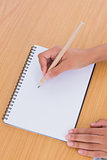 Woman drawing on a paper on a desk