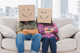 Funny workers with arms crossed wearing boxes on their heads