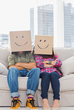 Funny workers with arms folded wearing boxes on their heads