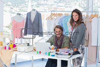 Young fashion designers smiling to the camera
