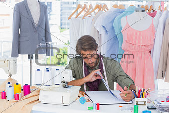 Fashion designer sitting behind a desk