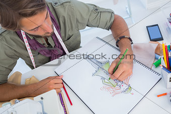 Fashion designer creating a coat for woman