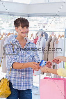 Woman giving her credit card to cashier