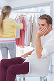 Desperate man being bored while his girlfriend is shopping
