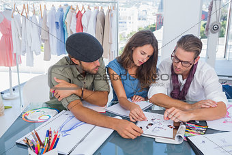 Three fashion designers working in a bright office