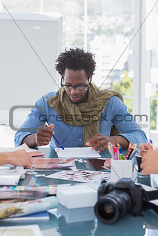 Photo editor brainstorming with his colleagues