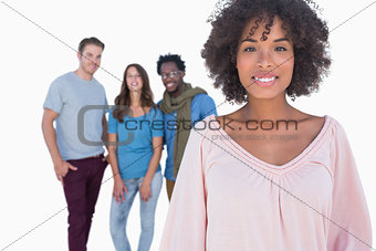 Fashionable woman smiling in front of stylish people